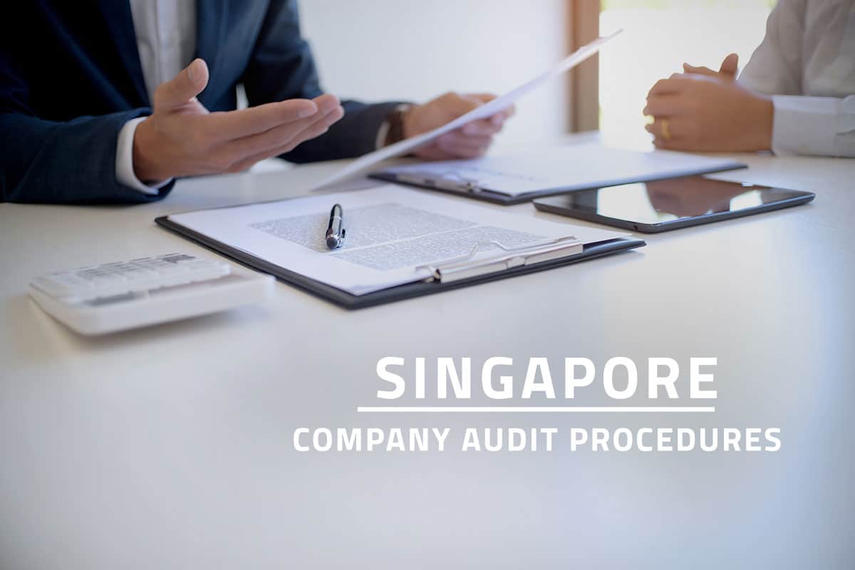 words Singapore company audit procedures overlaying background showing company auditor or internal revenue staff discussing company financial statements