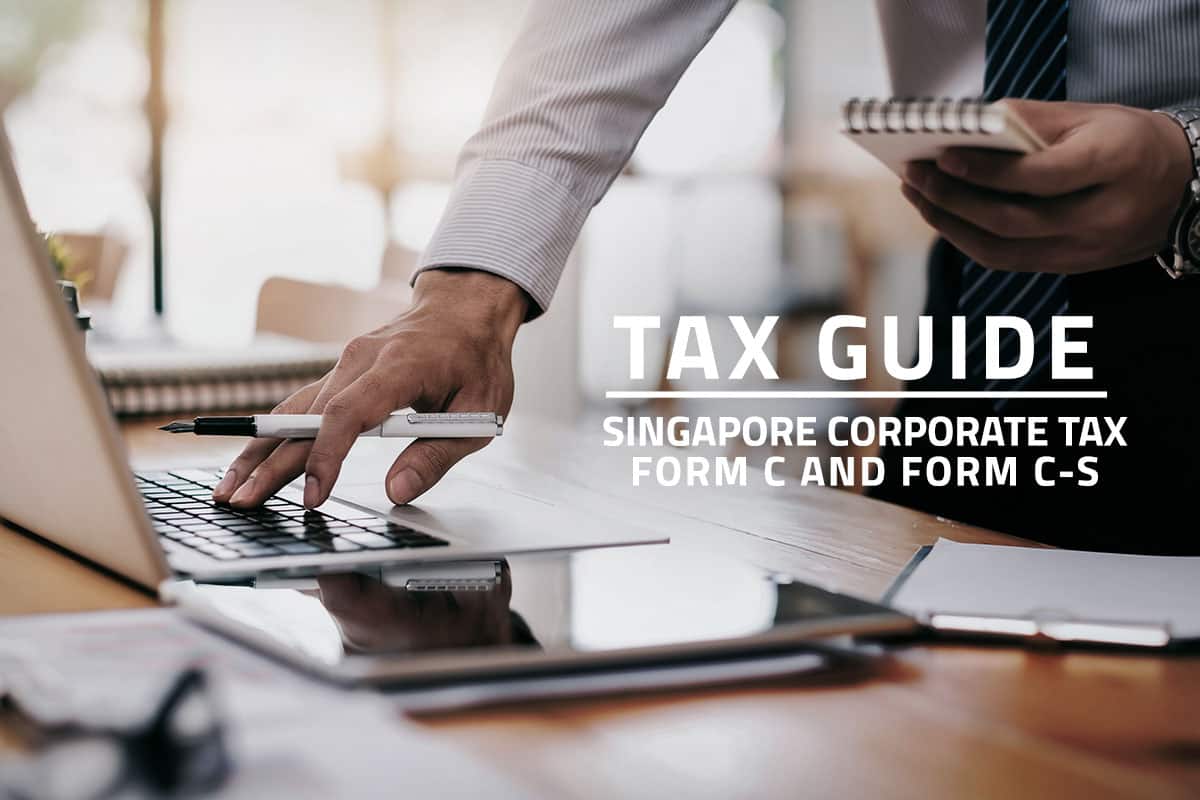 words tax guide Singapore corporate tax form c and form c-s against background of a corporate employee using a laptop on a desk